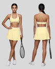 Front and Back view of a model wearing the CourtClub Color Block Halter Sports Bra in Light Yellow