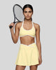 Model wearing the CourtClub Color Block Halter Sports Bra in Light Yellow viewed from the front