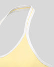 Side view highlighting the sleek profile and supportive fit of the CourtClub Color Block Halter Sports Bra in Light Yellow
