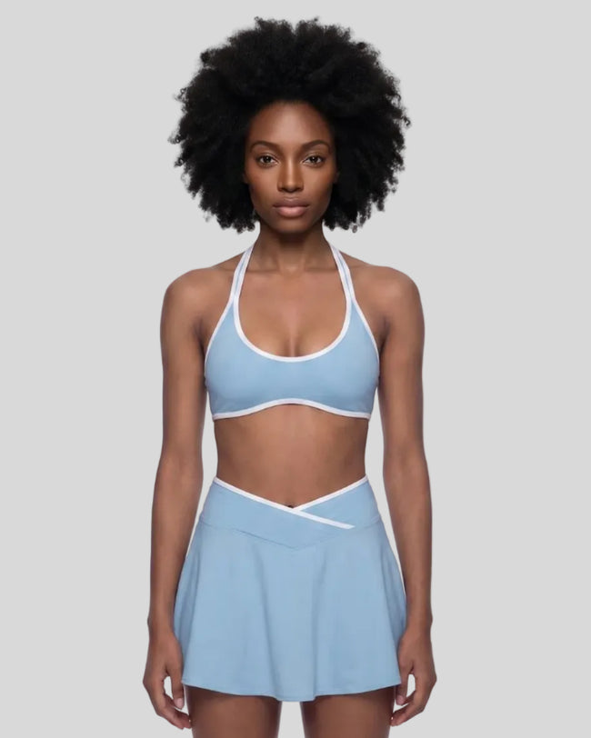Model wearing the CourtClub Color Block Halter Sports Bra in Sky Blue viewed from the front