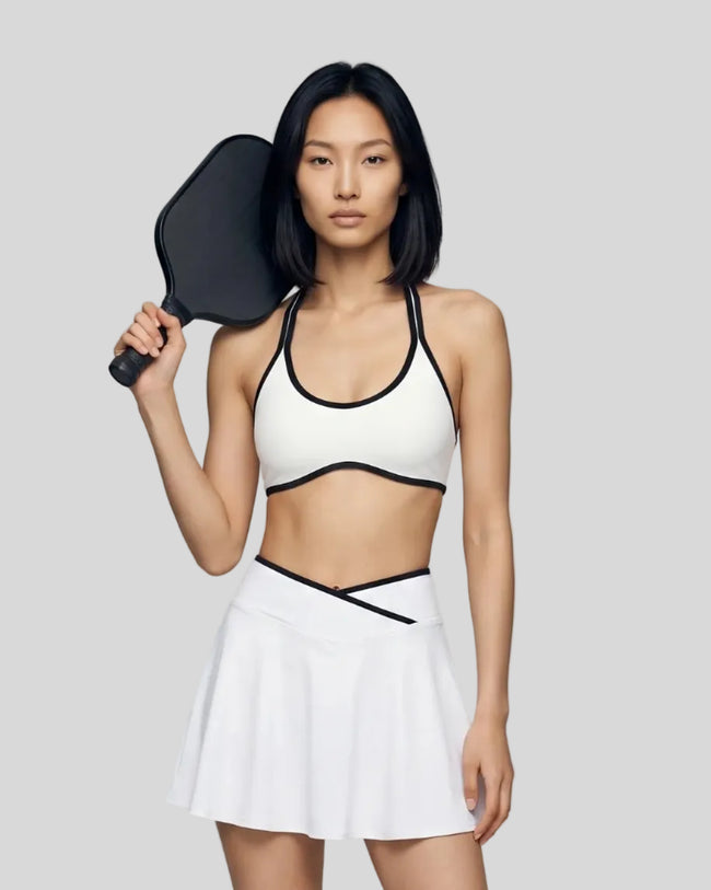 Model wearing the CourtClub Color Block Halter Sports Bra in White viewed from the front