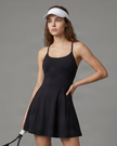 Woman wearing CourtClub Crossback Dress in Black, mid-body front view highlighting the fitted bodice