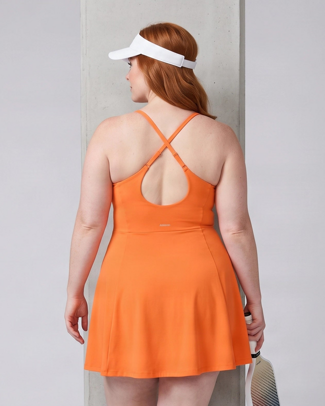 Woman wearing CourtClub Crossback Dress in Orange, mid-body back view highlighting the fitted bodice