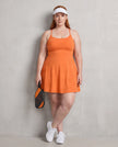 Woman wearing CourtClub Crossback Dress in Orange, full-body front view