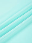 Close-up of smooth stretch fabric on CourtClub Crossback Dress in Sky Blue
