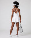 Woman wearing CourtClub Crossback Dress in White, mid-body back view highlighting the crisscross straps and open keyhole detail