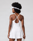 Woman wearing CourtClub Crossback Dress in White, mid-body back view highlighting the fitted bodice