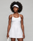 Woman wearing CourtClub Crossback Dress in White, mid-body front view highlighting the fitted bodice