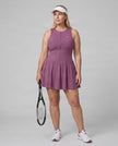 Woman wearing the Athlesi CourtClub Full-Zip Dress in Deep Purple, full-body front view styled for court and club.