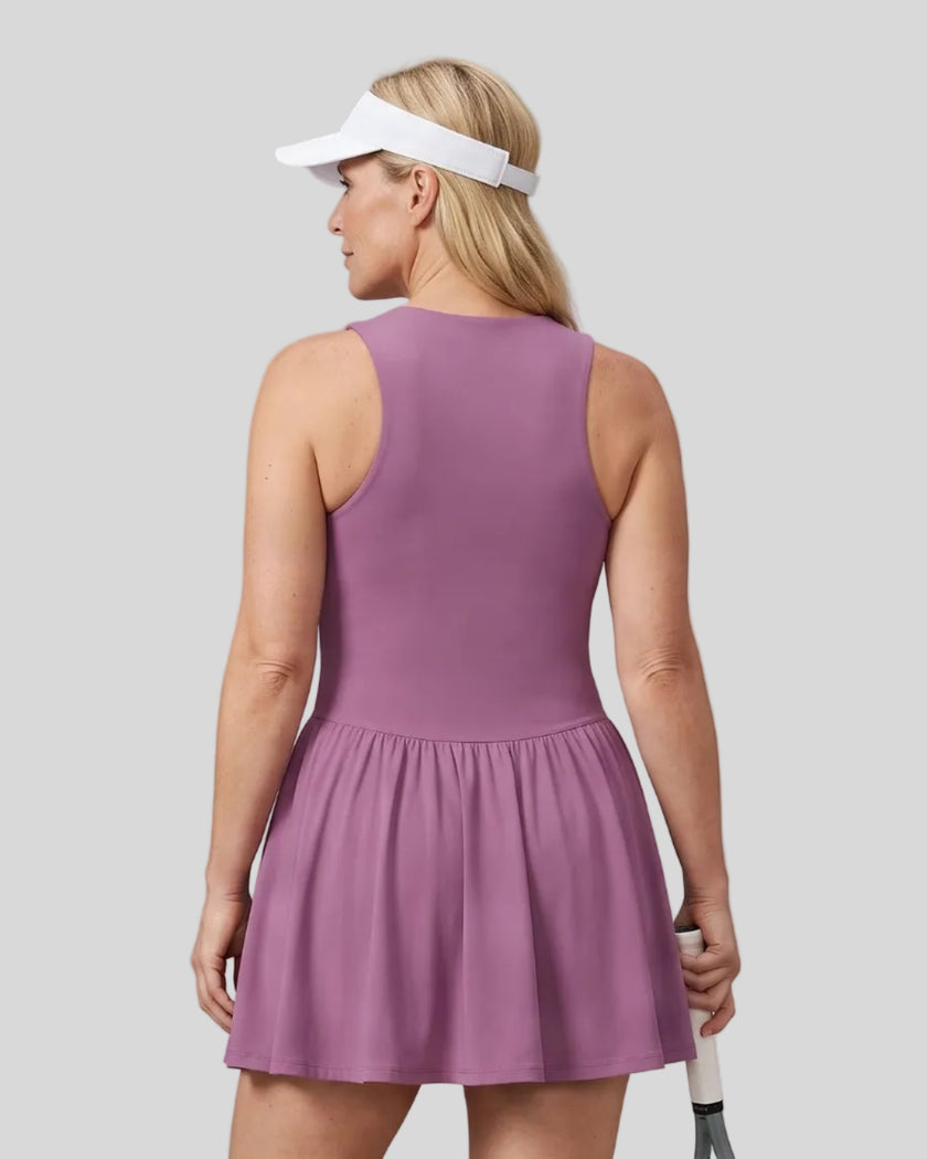 Woman wearing the Athlesi CourtClub Full-Zip Dress in Deep Purple, closer back view highlighting the sleeveless fit and waistline.