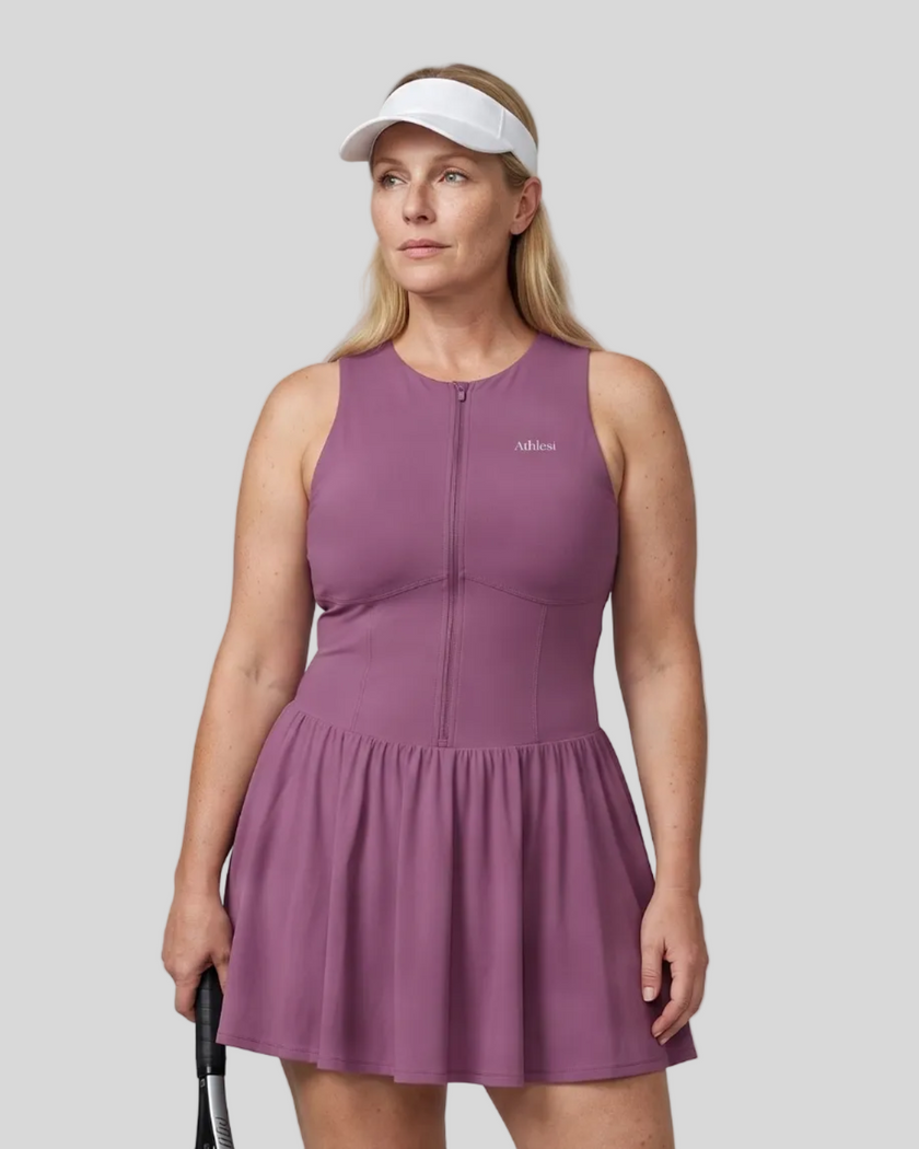 Woman wearing the Athlesi CourtClub Full-Zip Dress in Deep Purple, closer front view highlighting the neckline, zipper and fitted bodice.