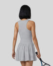 Woman wearing the Athlesi CourtClub Full-Zip Dress in Gray, closer back view highlighting the sleeveless fit and waistline.
