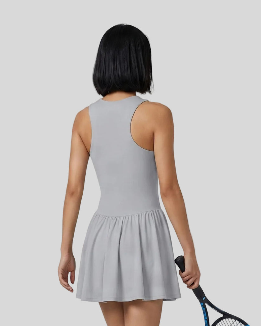 Woman wearing the Athlesi CourtClub Full-Zip Dress in Gray, closer back view highlighting the sleeveless fit and waistline.