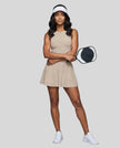 Woman wearing the Athlesi CourtClub Full-Zip Dress in Khaki, full-body front view styled for court and club.