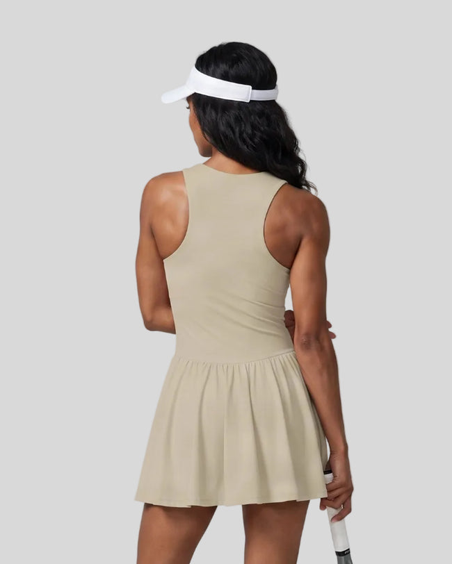 Woman wearing the Athlesi CourtClub Full-Zip Dress in Khaki, closer back view highlighting the sleeveless fit and waistline.