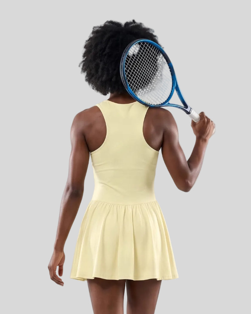 Woman wearing the Athlesi CourtClub Full-Zip Dress in Light Yellow, closer back view highlighting the sleeveless fit and waistline.