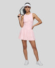 Woman wearing the Athlesi CourtClub Full-Zip Dress in Pink, full-body front view styled for court and club.