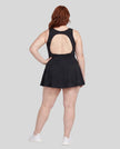 Woman wearing Athlesi CourtClub Open-Back Tennis Dress in Black full-body back view showing open-back design