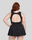 Woman wearing Athlesi CourtClub Open-Back Tennis Dress in Black mid-body back view highlighting statement open-back detail
