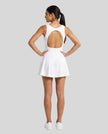 Woman wearing Athlesi CourtClub Open-Back Tennis Dress in White full-body back view showing open-back design