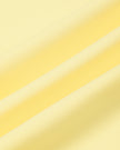 Athlesi CourtClub Open-Back Tennis Dress in Yellow closeup showing smooth nylon-blend stretch fabric
