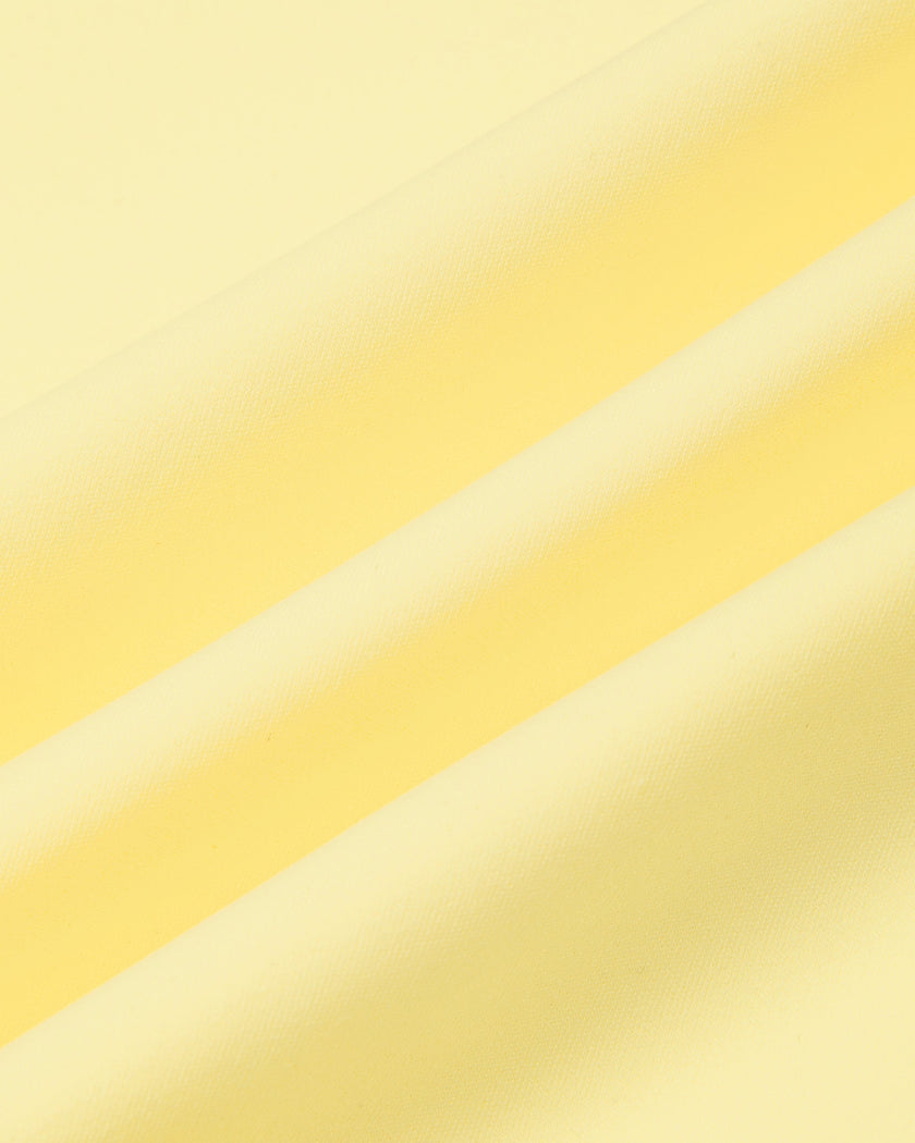 Athlesi CourtClub Open-Back Tennis Dress in Yellow closeup showing smooth nylon-blend stretch fabric