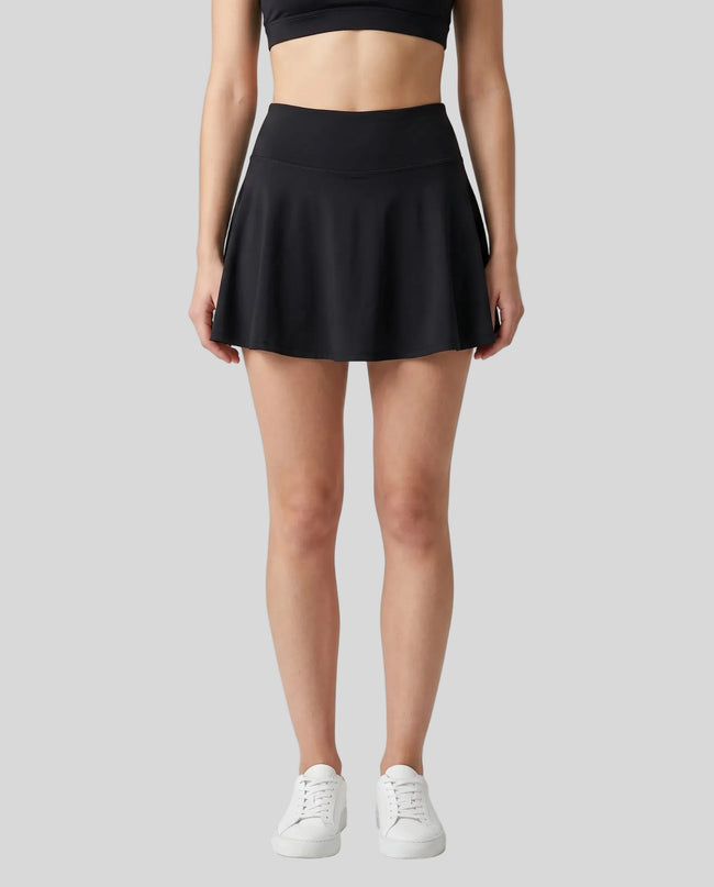 Model wearing the CourtClub Pleated Skirt in Black viewed from the front