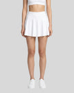 Model wearing the CourtClub Pleated Skirt in White viewed from the front