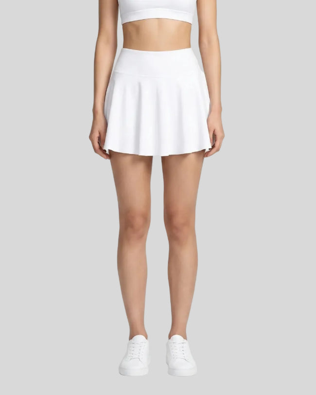 Model wearing the CourtClub Pleated Skirt in White viewed from the front