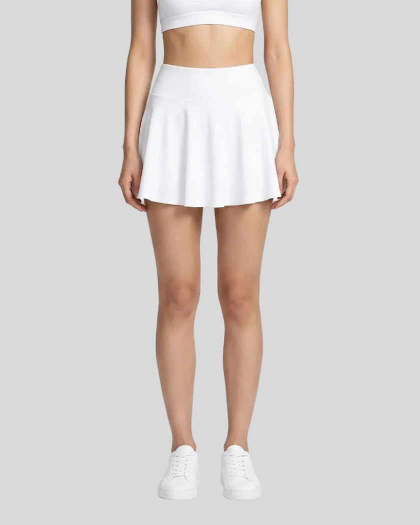 Model wearing the CourtClub Pleated Skirt in White viewed from the front
