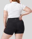Woman wearing Athlesi CourtClub Tennis Short in Black mid-body back view highlighting sculpted waistband seam and fit