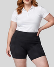 Woman wearing Athlesi CourtClub Tennis Short in Black mid-body front view highlighting waistband and fitted silhouette