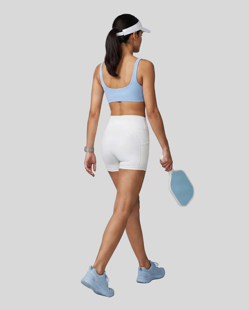 Woman wearing Athlesi CourtClub Tennis Short in White full-body back view showing high-rise fit