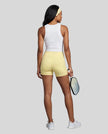 Woman wearing Athlesi CourtClub Tennis Short in Yellow full-body back view showing high-rise fit