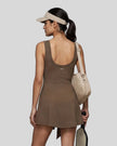 Woman wearing the Athlesi CourtClub Tie-Front Dress in Coffee, mid-body back view highlighting the scoop neckline and fit.