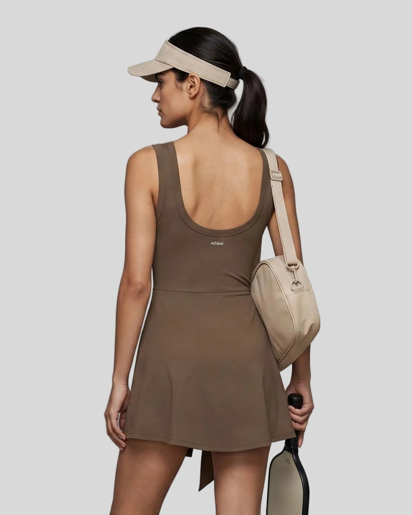 Woman wearing the Athlesi CourtClub Tie-Front Dress in Coffee, mid-body back view highlighting the scoop neckline and fit.