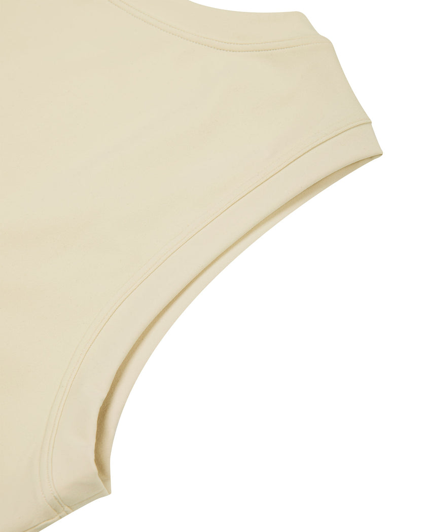 Close-up of the sleeveless armhole construction on the Athlesi CourtClub Tie-Front Dress in Light Apricot.