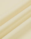 Close-up of the smooth stretch fabric on the Athlesi CourtClub Tie-Front Dress in Light Apricot.