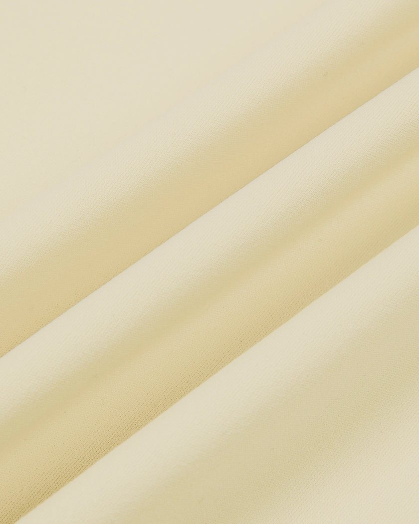 Close-up of the smooth stretch fabric on the Athlesi CourtClub Tie-Front Dress in Light Apricot.