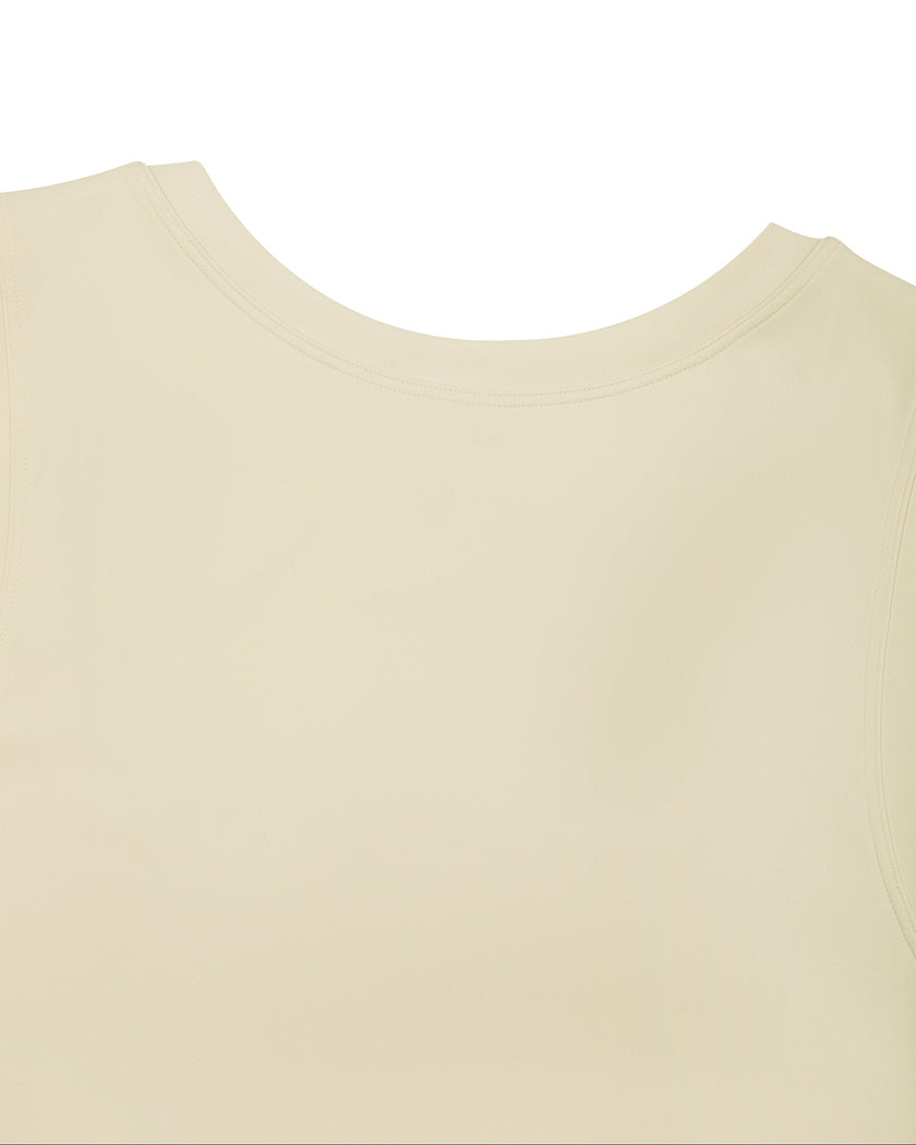 Close-up of the front round neckline on the Athlesi CourtClub Tie-Front Dress in Light Apricot.