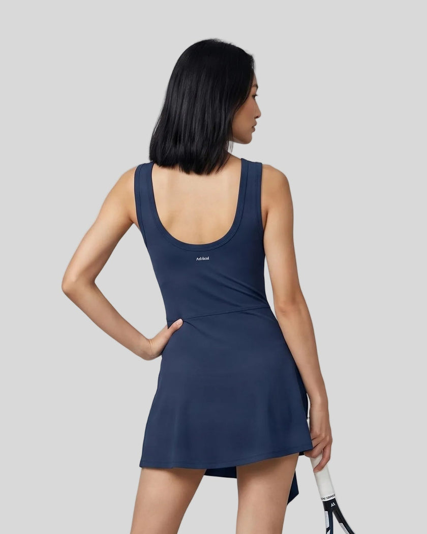 Woman wearing the Athlesi CourtClub Tie-Front Dress in Navy Blue, mid-body back view highlighting the scoop neckline and fit.