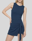 A woman modeling a Navy Blue CourtClub Tie-Front Dress with a wrap-style skirt and side tie, shown against a plain white studio background.