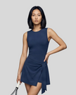 Woman wearing the Athlesi CourtClub Tie-Front Dress in Navy Blue, mid-body front view highlighting the asymmetric tie detail.