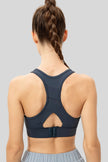 Back view of Athlesi CourtEase sports bra showing racerback cutout design in deep teal