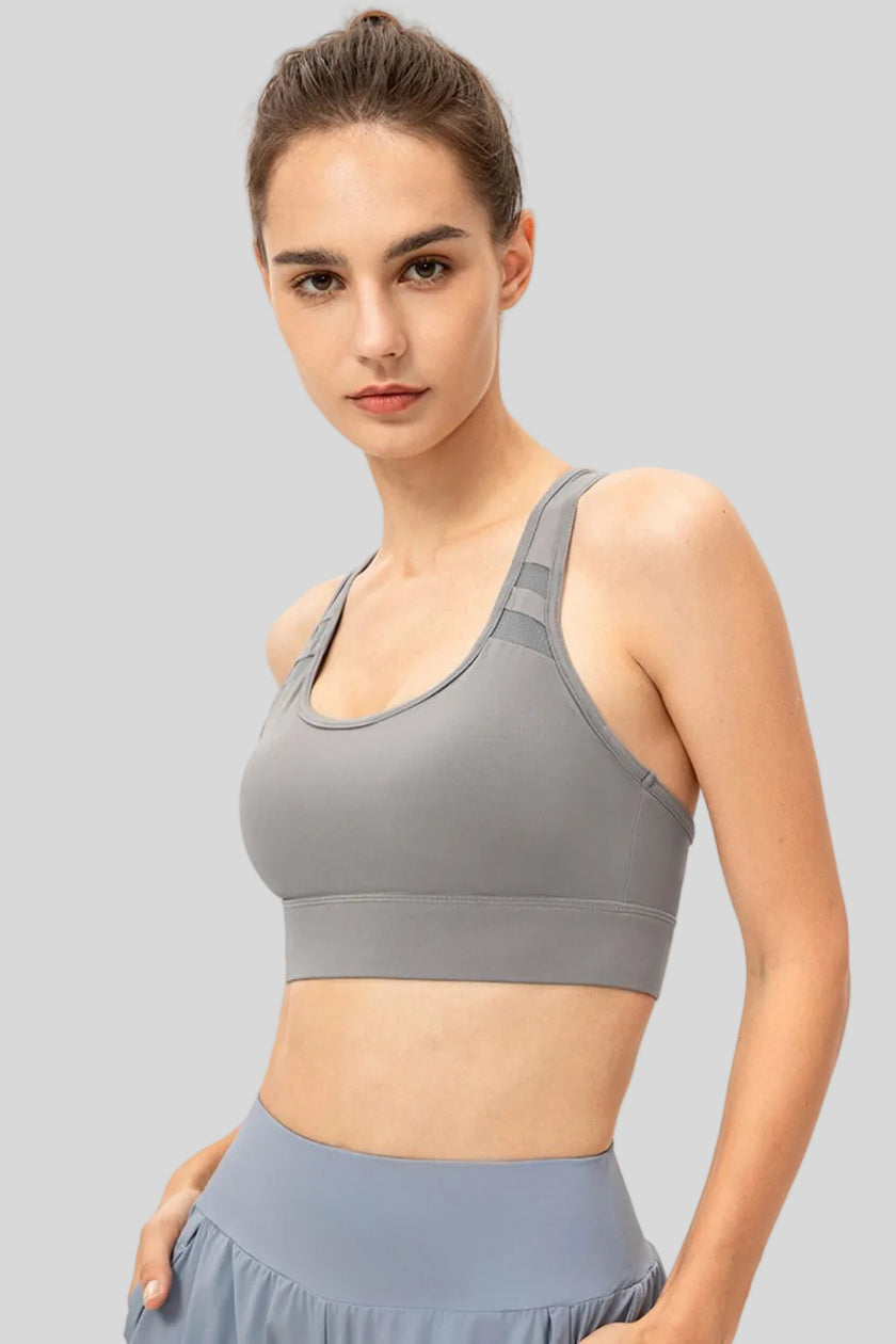 Front angle view of Athlesi CourtEase longline sports bra in light gray