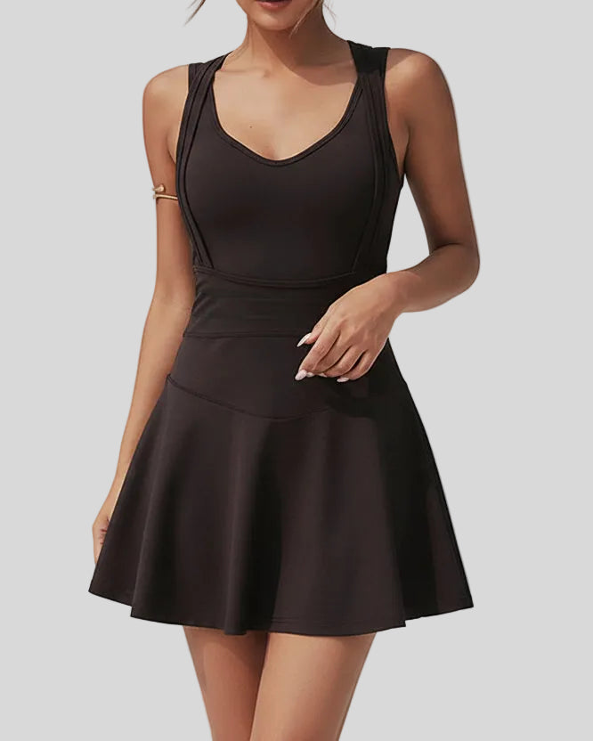 Side view of the CourtFlow Active Dress in Black highlighting fluid skirt and active fit