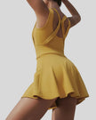Back view of the CourtFlow Active Dress in mustard showing wide straps and built-in liner