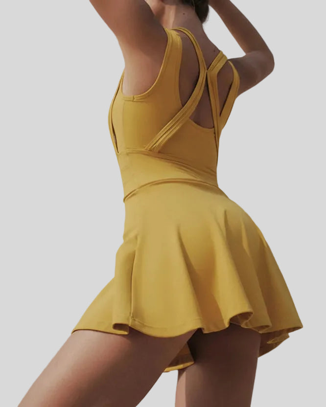 Back view of the CourtFlow Active Dress in mustard showing wide straps and built-in liner