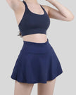 Dark blue athletic skort with a flowy skirt overlay and built-in compression shorts - Athlesi