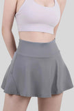 Close-up of a dark gray, moisture-wicking tennis skirt with a wide waistband - Athlesi
